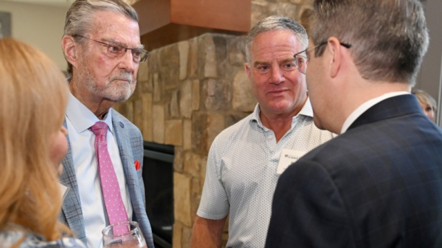 Keen, in black suit with wife Karen to his left, with others during Gainesville stop. (augustaceo.com photo)