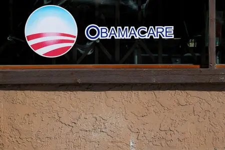 FILE PHOTO: A sign on an insurance store advertises Obamacare in San Ysidro, San Diego, California, U.S., October 26, 2017. REUTERS/Mike Blake/File Photo