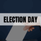 Text says election day with man casting ballot into ballot box in background.
