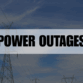 Rectangle containing the text Power Outages with power transformers in the background