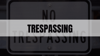 Rectangle containing the word trespassing with trespassing sign in the background