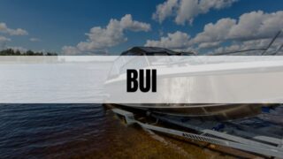 Text that says BUI on top of a white rectangle with a boat on a lake in the background.