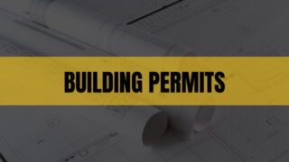Text that says Building Permits on a light orange rectangle with construction plans in the background