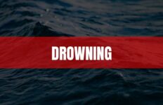 Text that says Drowning on a red rectangle with water in the background