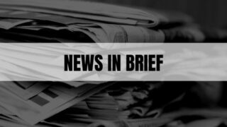 Text that says News In Brief on a white rectangle with newspapers in the background