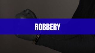 Text that says Robbery on a blue rectangle with a robber's hand in handcuffs in the background