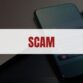 Red text that says Scam on a white rectangle with a smartphone in the background