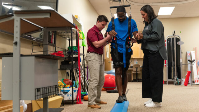 PT students model exercises and equipment they use with patients in the pro-bono clinic (Sidney Chansamone/Brenau University)