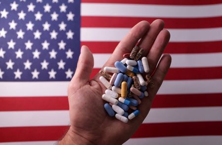 U.S. flag and medicines are seen in this illustration taken, June 27, 2024. REUTERS/Dado Ruvic/Illustration