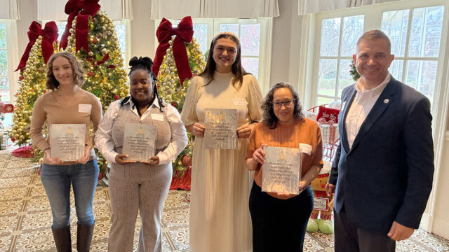 Six nontraditional female students at UNG each earned a $2,000 scholarship from the Women of UNG and other supporters and were honored Dec. 4 at the Women's Holiday Scholarship Luncheon. Pictured are four of them, L-R Cristin Gibson, Dykejiah Jones, Madison Lussier, and Melody Rodriguez with UNG President Michael Shannon. (UNG photo)