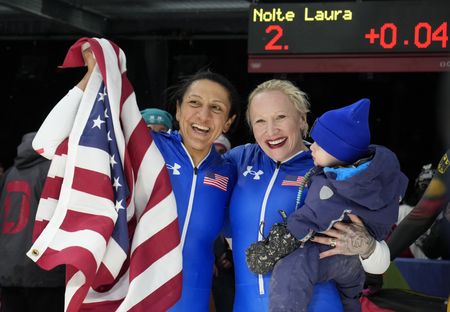 Elana Meyers Taylor of Douglasville (left) and Kaillie Armbruster Humphries of the U.S. celebrate after placing first and third in the women's bobsleigh monobob competition during the Milano Cortina 2026 Olympic Winter Games at Cortina Sliding Centre. Mandatory (Credit: Michael Madrid-Imagn Images)