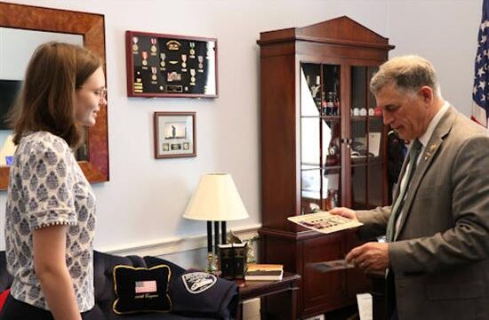 Rep. Clyde examines Pethel’s winning bookmark and license plate. (Andrew Clyde photo)