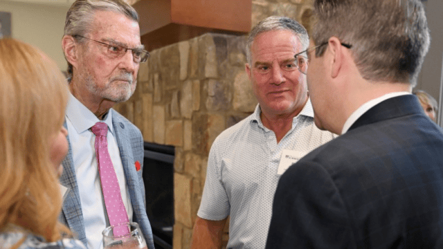 Keen, in black suit with wife Karen to his left, with others during Gainesville stop. (augustaceo.com photo)