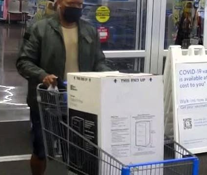 Caught on camera: One of the thieves leaving an unidentified store with merchandise he didn't pay for. (Cherokee Co. District Attorney's Office)