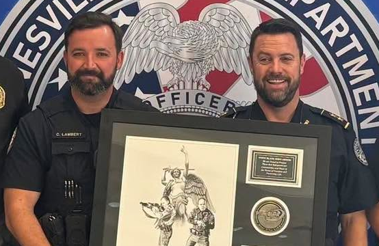 Chief Jay Parrish (right) with officer who was wounded but not identified by the department in Saturday's posting.(GPD photo)